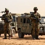 Military personnel and security vehicles stationed at a rural base in bauchi state.